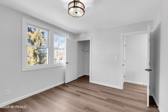 unfurnished bedroom featuring a closet and light hardwood / wood-style flooring