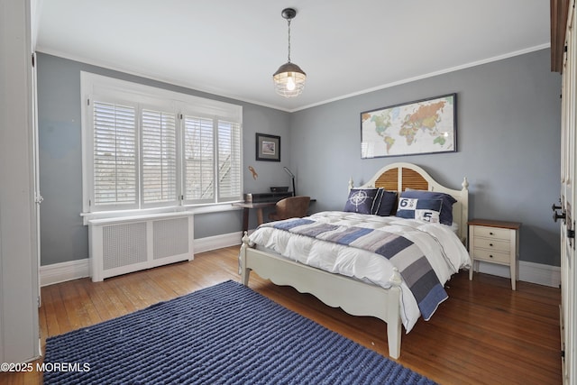 bedroom with wood-type flooring, radiator, and ornamental molding