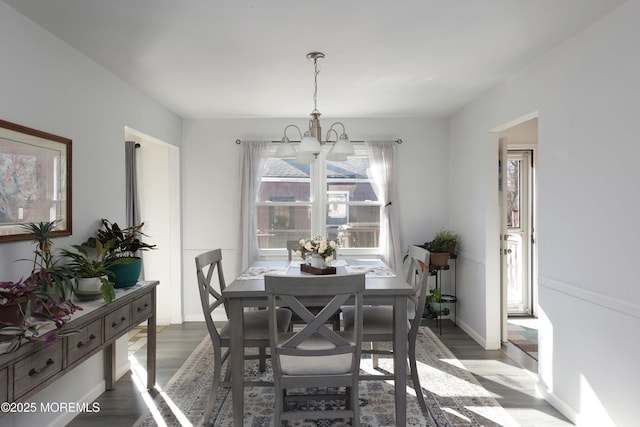 dining area featuring hardwood / wood-style floors and a notable chandelier