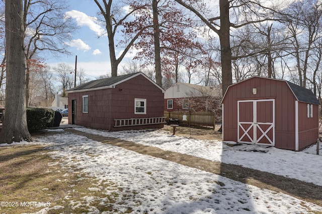 yard layered in snow with a shed