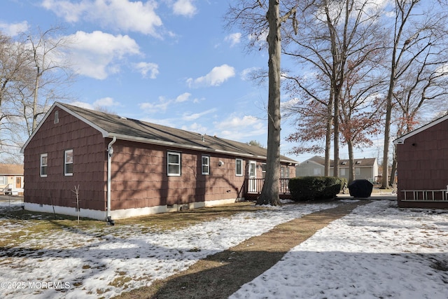 snow covered property featuring a wooden deck