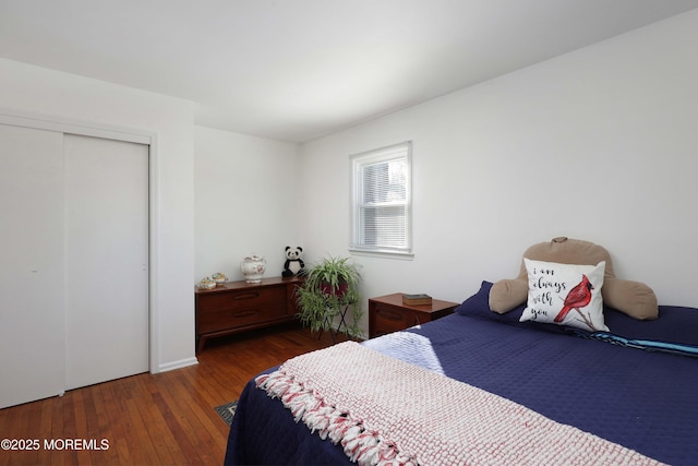 bedroom with a closet and dark hardwood / wood-style floors