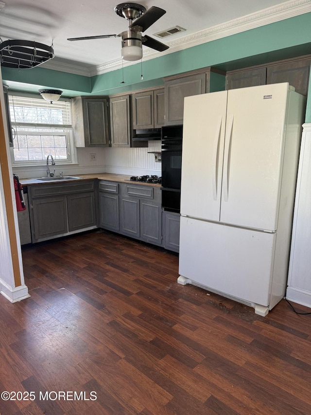 kitchen with gray cabinets, dark hardwood / wood-style floors, sink, oven, and white refrigerator