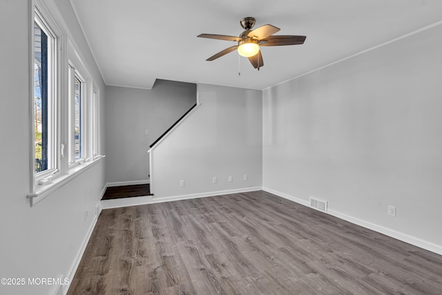 unfurnished living room featuring wood-type flooring and ceiling fan