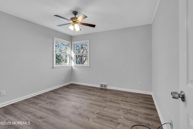 spare room with hardwood / wood-style flooring and ceiling fan