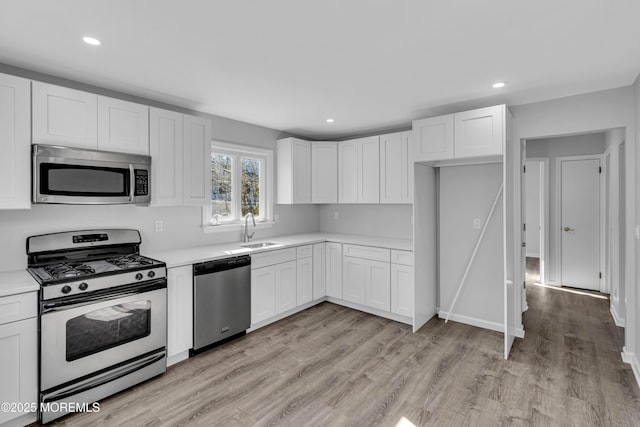 kitchen featuring sink, stainless steel appliances, and white cabinets