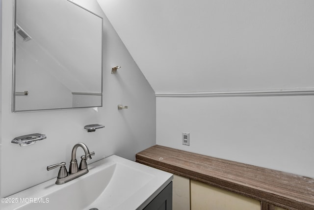 bathroom with vanity and vaulted ceiling