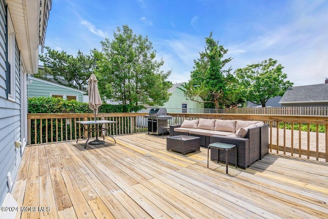 wooden deck featuring grilling area and an outdoor hangout area