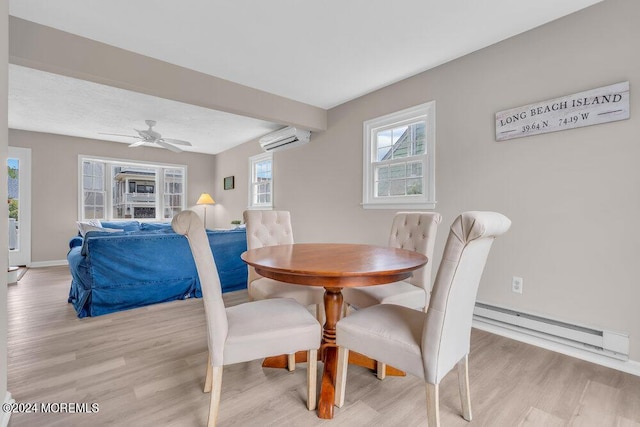 dining space with a baseboard radiator, ceiling fan, a wall unit AC, and light hardwood / wood-style flooring