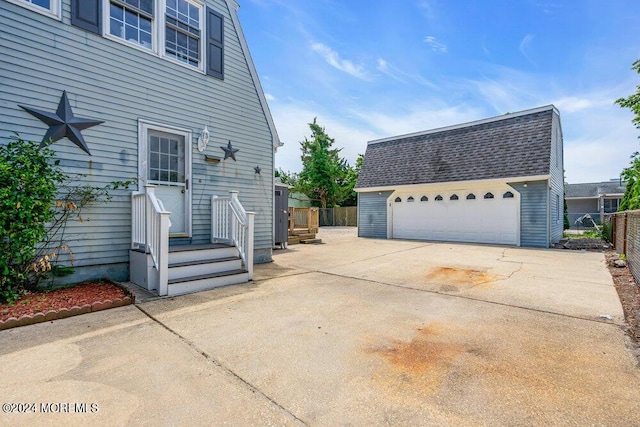 view of side of home featuring an outbuilding and a garage