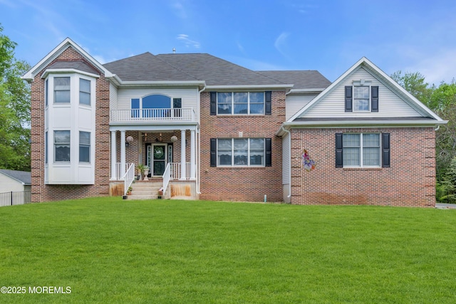 9 Mehar Ct, Jackson, NJ 08527 - view of front facade featuring a balcony, a front lawn, and brick siding