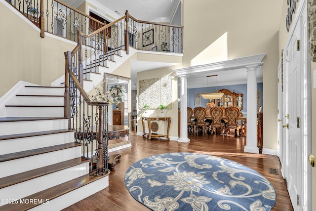9 Mehar Ct, Jackson, NJ 08527 - foyer entrance featuring decorative columns, a high ceiling, wood finished floors, baseboards, and crown molding
