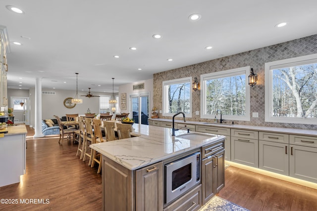9 Mehar Ct, Jackson, NJ 08527 - kitchen with stainless steel microwave, a sink, recessed lighting, ornate columns, and dark wood finished floors