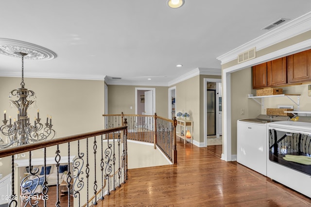 9 Mehar Ct, Jackson, NJ 08527 - corridor featuring independent washer and dryer, an upstairs landing, a chandelier, wood finished floors, and recessed lighting
