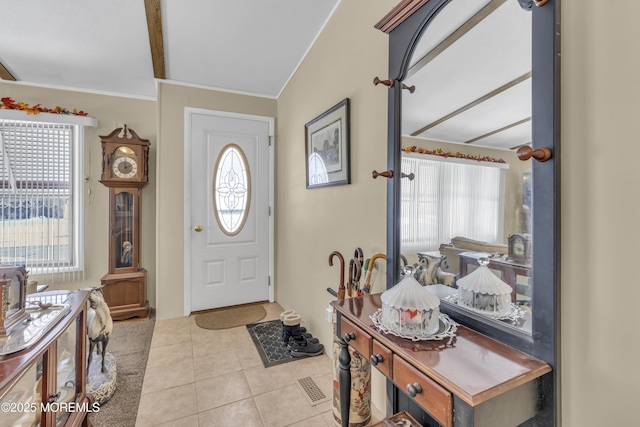 tiled entrance foyer featuring ornamental molding