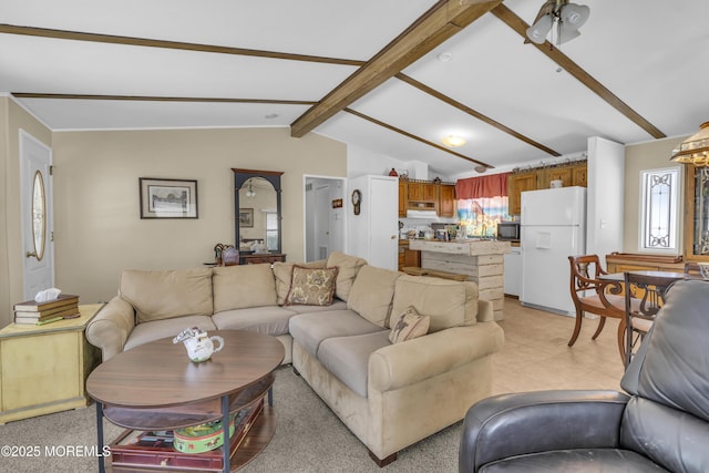 living room with lofted ceiling with beams