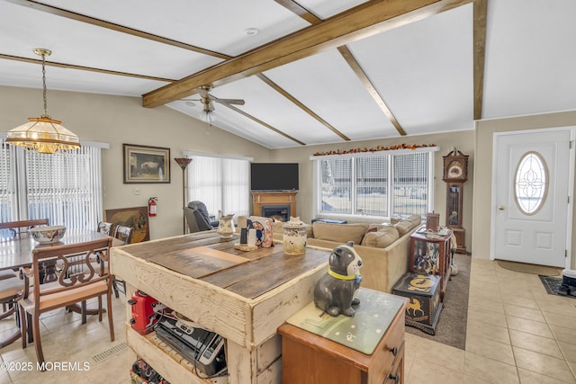 interior space featuring ceiling fan, lofted ceiling with beams, and light tile patterned floors