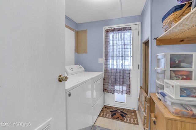 laundry room featuring separate washer and dryer and crown molding