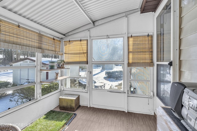 unfurnished sunroom with lofted ceiling