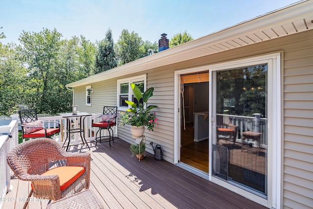 wooden terrace with outdoor dining space