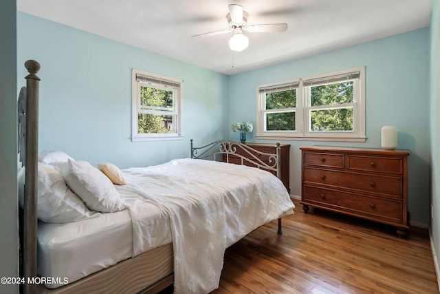 bedroom with ceiling fan and wood finished floors