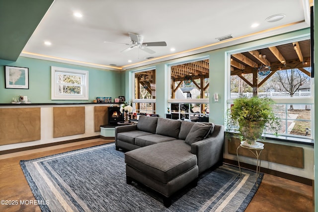 living area featuring plenty of natural light, visible vents, crown molding, and recessed lighting