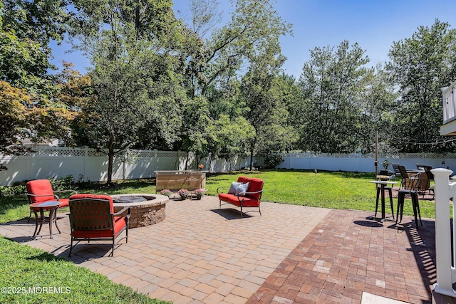 view of patio / terrace with a fenced backyard and a fire pit