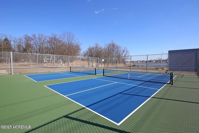 view of sport court featuring fence