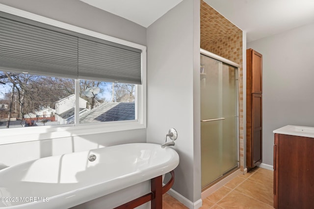 bathroom featuring plus walk in shower, tile patterned floors, and vanity