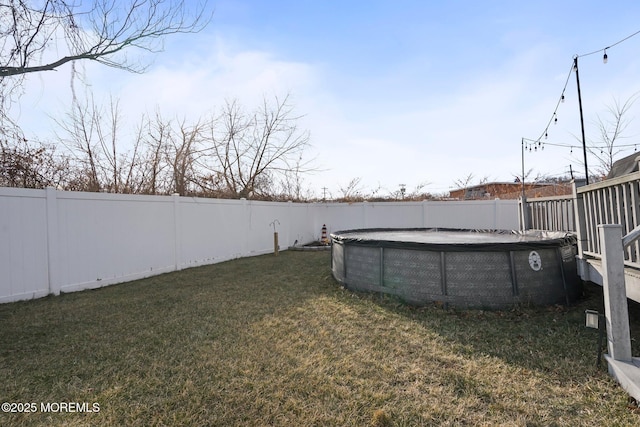 view of yard featuring a covered pool