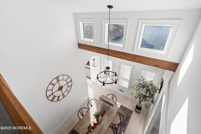 room details featuring hardwood / wood-style flooring and an inviting chandelier