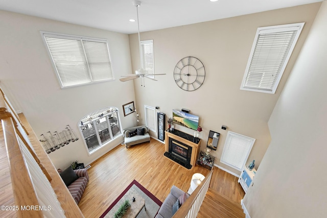 living room with hardwood / wood-style flooring and ceiling fan