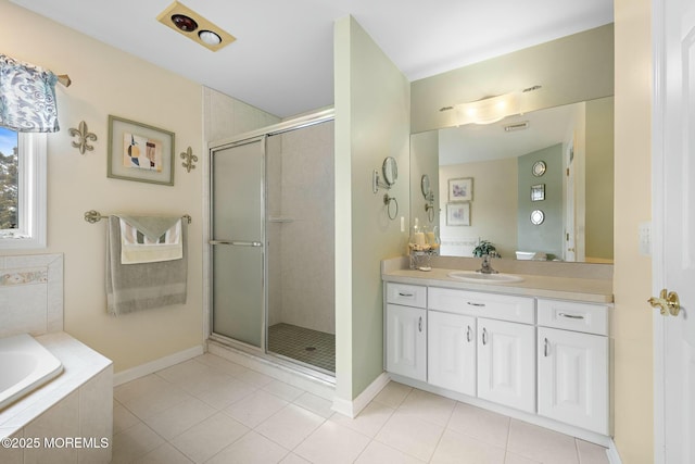 bathroom with vanity, tile patterned floors, and plus walk in shower