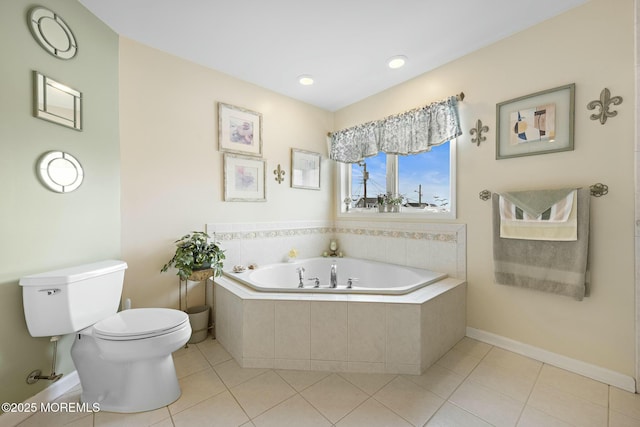 bathroom featuring a relaxing tiled tub, tile patterned floors, and toilet