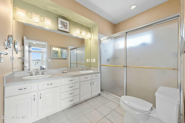 bathroom featuring vanity, tile patterned floors, toilet, and walk in shower