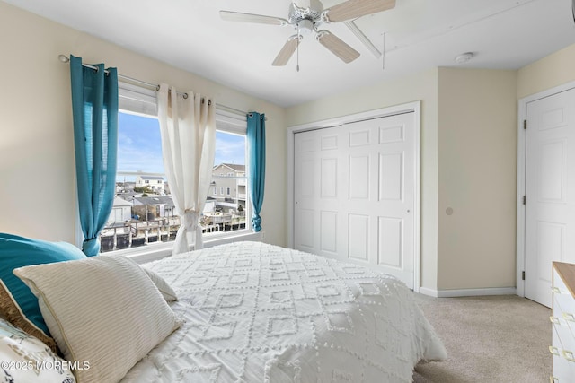 carpeted bedroom with a closet and ceiling fan