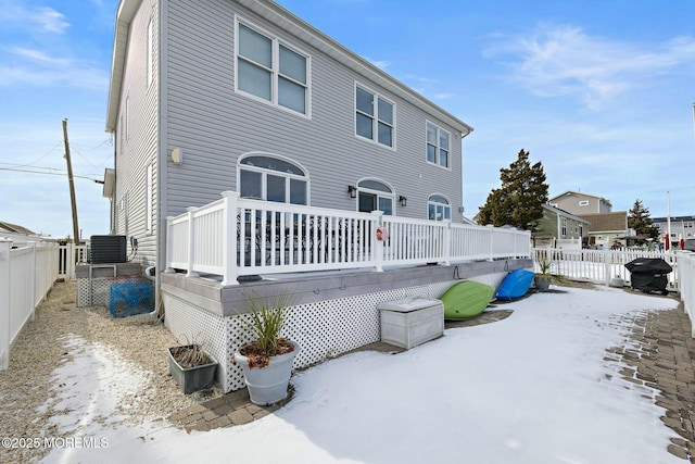 snow covered property with cooling unit