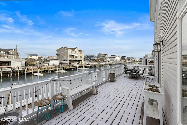 exterior space featuring a deck with water view