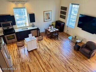 interior space with stainless steel appliances and wood finished floors