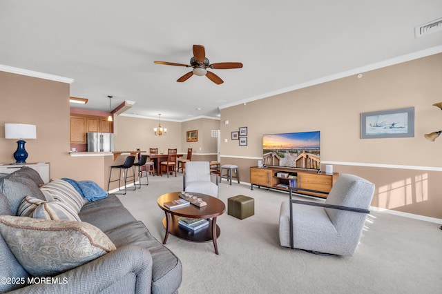 living room featuring crown molding, ceiling fan with notable chandelier, and light colored carpet