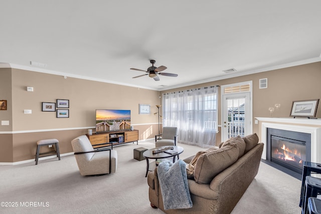 living room featuring crown molding, light colored carpet, and ceiling fan