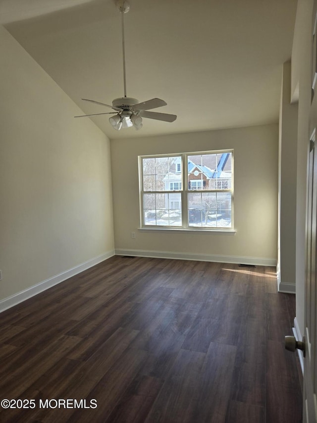 spare room with ceiling fan, lofted ceiling, and dark hardwood / wood-style flooring