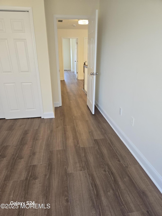 hall with dark wood-type flooring