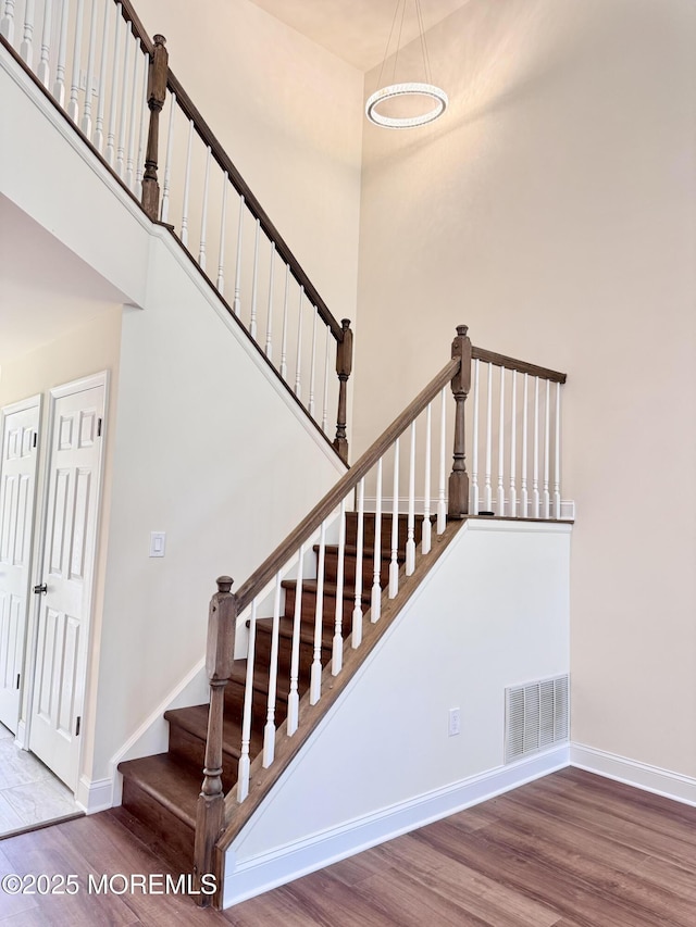 327 Daniele Dr, Ocean Twp, NJ 07712 - staircase with wood finished floors and a towering ceiling