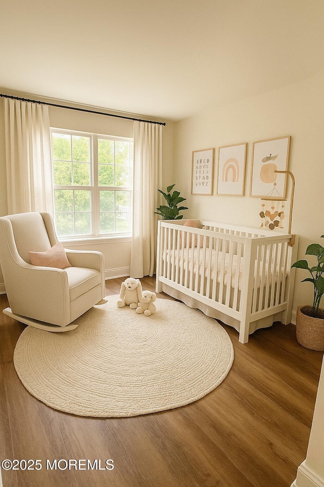327 Daniele Dr, Ocean Twp, NJ 07712 - bedroom featuring wood finished floors and a crib