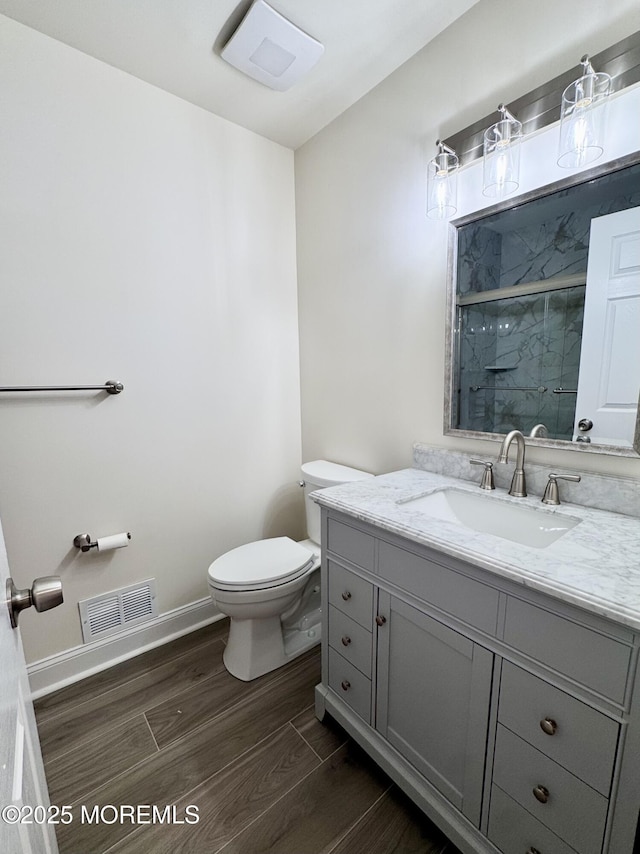 327 Daniele Dr, Ocean Twp, NJ 07712 - bathroom with vanity, a stall shower, and wood finished floors