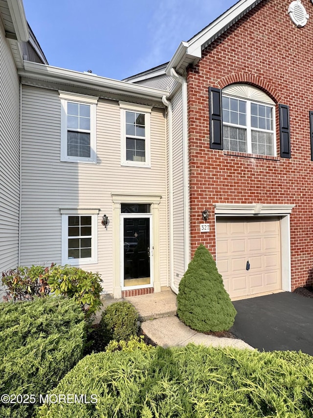 327 Daniele Dr, Ocean Twp, NJ 07712 - view of front of home with driveway, an attached garage, and brick siding