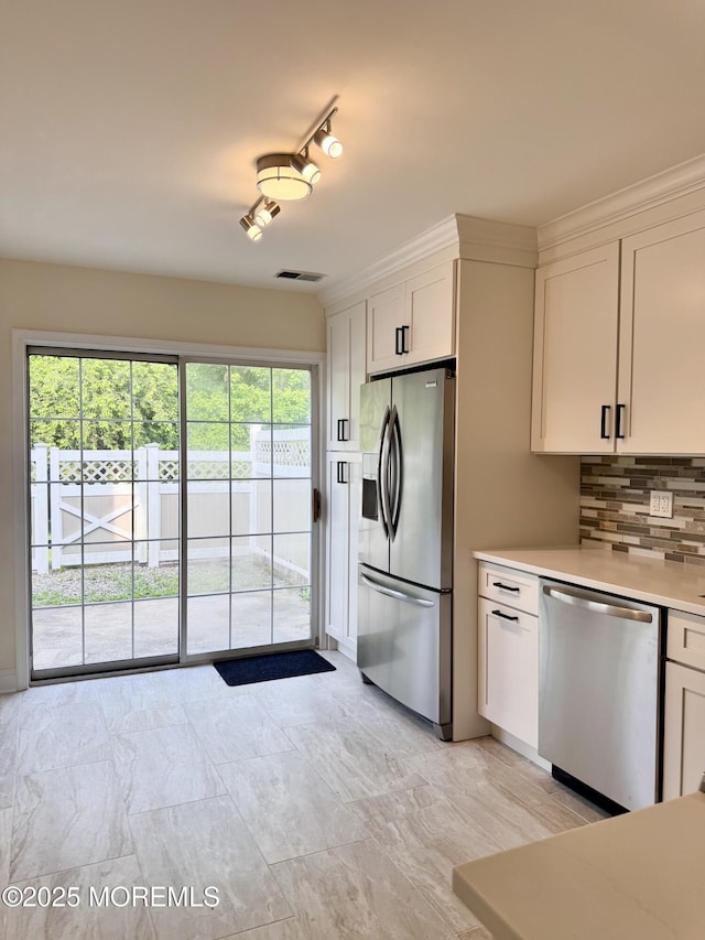 327 Daniele Dr, Ocean Twp, NJ 07712 - kitchen featuring stainless steel appliances, light countertops, white cabinets, and tasteful backsplash