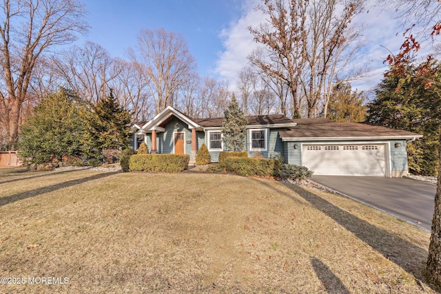 ranch-style home featuring an attached garage, driveway, and a front yard