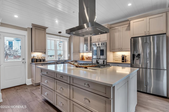 kitchen with island range hood, a center island, light hardwood / wood-style flooring, appliances with stainless steel finishes, and pendant lighting